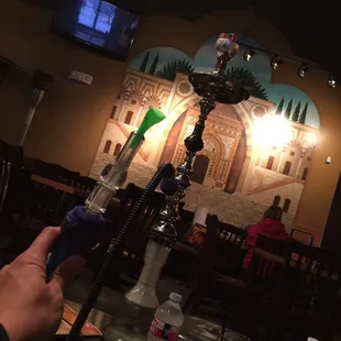 a hand holding a hookah