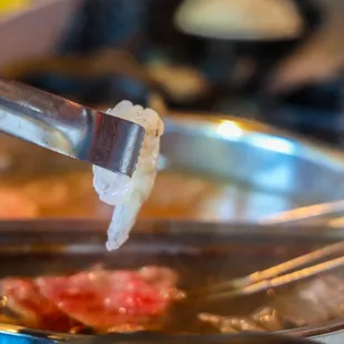 a person stirring food in a pot