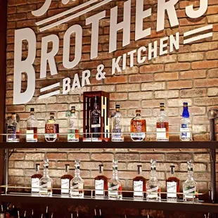 a brick wall with a sign that says five brothers bar and kitchen
