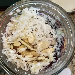 Acai in a Jar topped with coconut flakes, almonds and honey