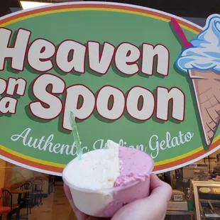 a small cup of Cheesecake and Raspberry in front of their logo