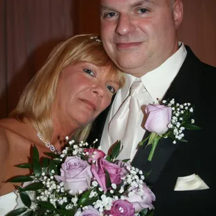 a bride and groom posing for a picture