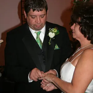 a bride and groom exchanging their wedding rings