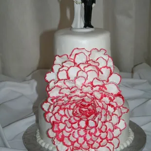 a wedding cake with a bride and groom on top