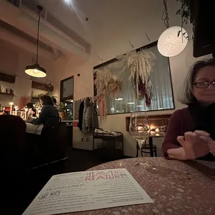 a woman sitting at a table in a restaurant