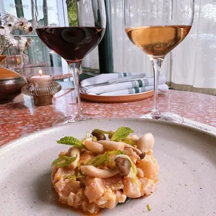 a plate of food and a glass of wine