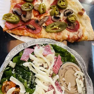 Lunch. Pepperoni pizza slice with mushrooms and jalapeños, side salad.