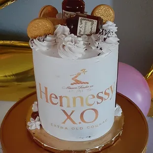 a cake with a bottle of hennessy xo on top
