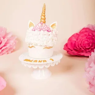 a cake with a unicorn on top