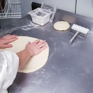 a person making a pizza