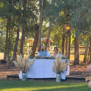 Sweetheart table in front of the eucalyptus grove