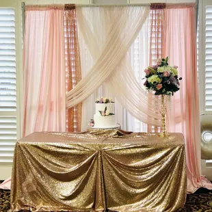 Pipe and drape stand with blush and sequin curtains