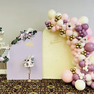 Double chiara backdrop with balloon garland and floral decor