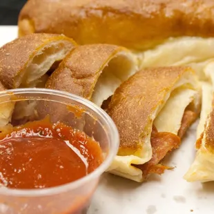 a hot dog with cheese and tomato sauce