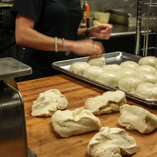 a woman preparing doughnuts in a kitchen