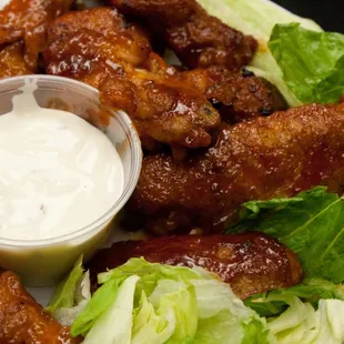 a plate of chicken wings and lettuce