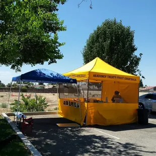 a yellow tent set up in a parking lot