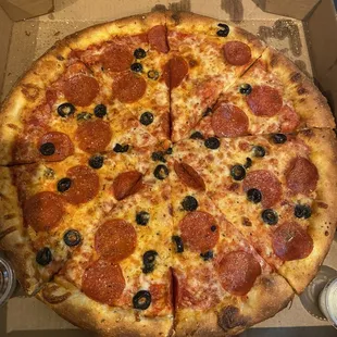 Large pizza with pepperoni and black olives