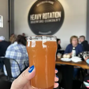 a person holding a glass of beer