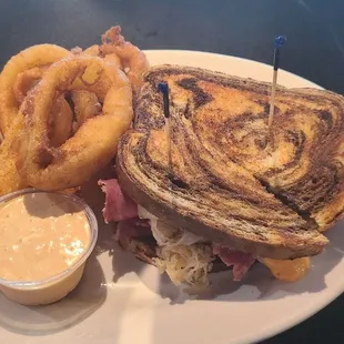 a grilled sandwich and onion rings