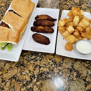Talipia Fish Sandwich, Fried Yuca bites with garlic sauce and sweet plantains.