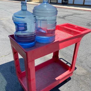 They provide carts so you can take your filled bottle back to your car.