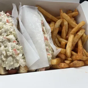 Two hotdogs coleslaw, and french fries seasoned fries
