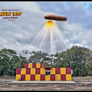 a hot dog flying over a building