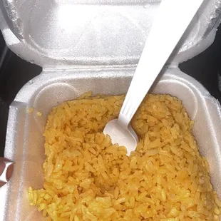 rice in a container with a spoon