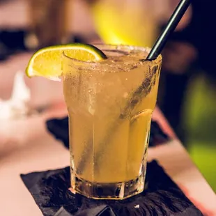 a cocktail with a slice of lemon