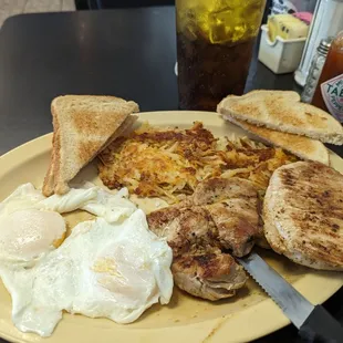 Two Eggs Over Easy with Two Pork Chops, Hashbrowns, and Toast.  Very Tasty!