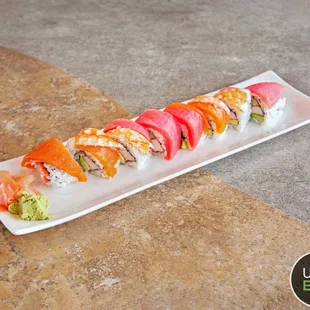 a sushi roll with salmon and avocado