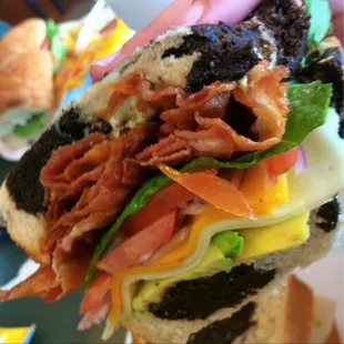 a hand holding a sandwich