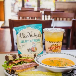 a bowl of soup and a sandwich on a plate