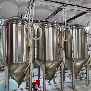 a row of stainless steel tanks