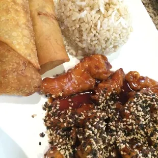 Sesame chicken with brown rice, spring roll and extra ($) Chinese egg roll.