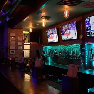 a bar with multiple televisions