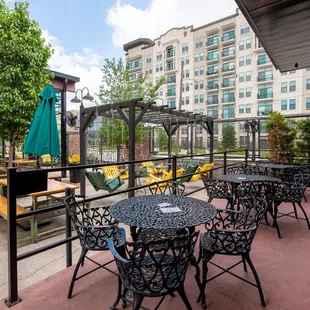 a patio with tables and chairs