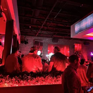 a group of people standing in front of a bar