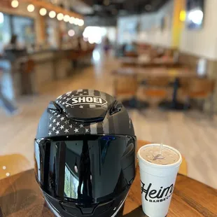 a helmet and a cup of coffee