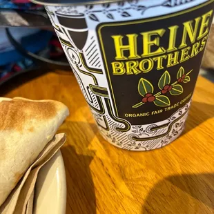 a cup of coffee and a sandwich