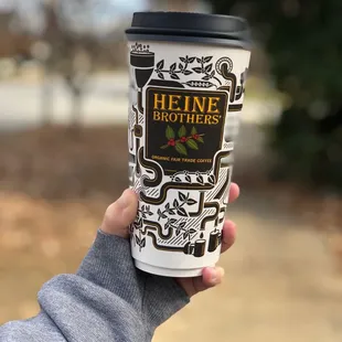 a hand holding a coffee cup