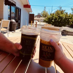  two people toasting at a table