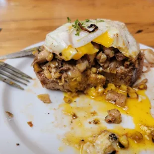 Caramelized mushroom toast with charred corn and fried egg.