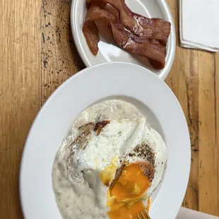 Biscuits and gravy with a farm fresh dark yolk egg.