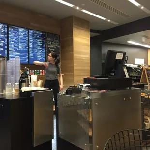 a man and a woman standing in a coffee shop