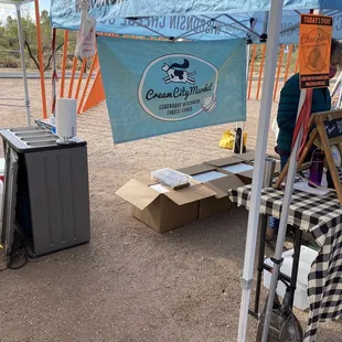 a man sitting under a tent