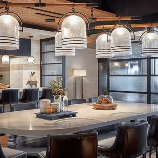 a kitchen with a large table and chairs