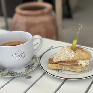 a sandwich and a cup of coffee