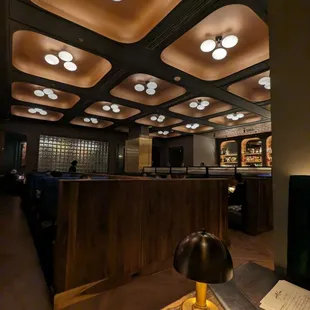 a wooden table with a lamp on it